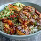 Vibrant Asian Shrimp Bowl with juicy grilled shrimp, crisp carrots, and edamame, drizzled with tangy ginger-sesame dressing over fluffy rice.