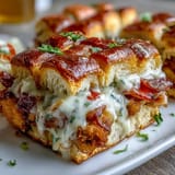 Derby Party Hot Brown Sliders on Brioche Buns with turkey, bacon, and creamy Mornay sauce, baked until golden and bubbly.  