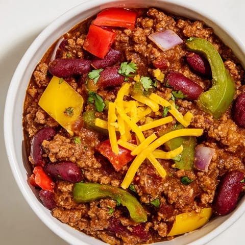 Easy weeknight Chili con Carne with kidney beans and bell peppers in a rustic pot.